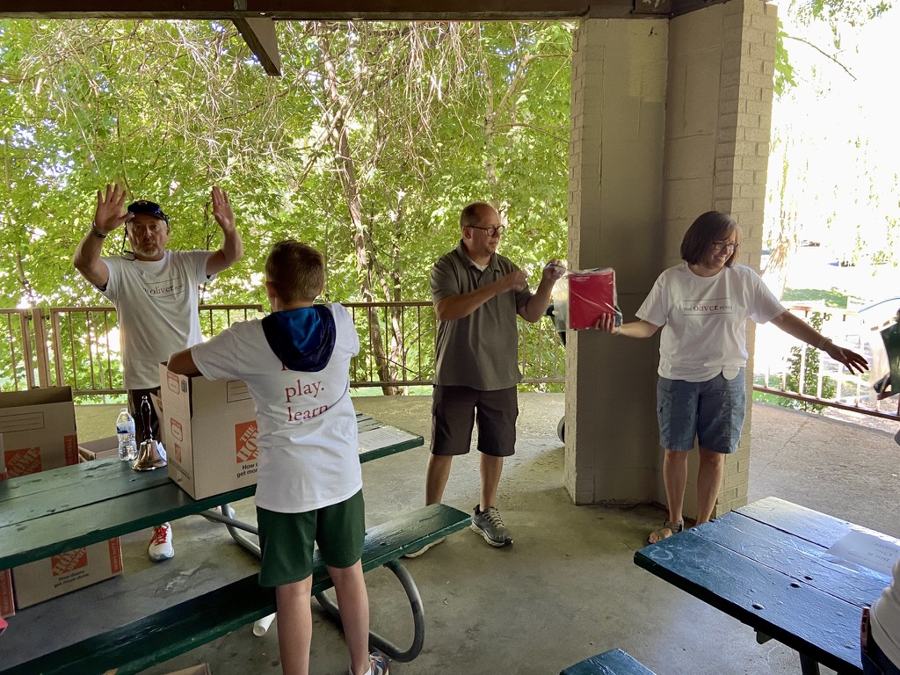 Ollie's Army volunteers passing boxes down a packing line